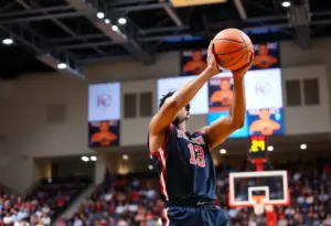 A basketball player shooting during a college game