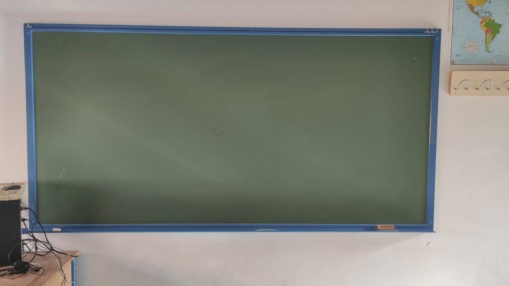 Blank chalkboard on a classroom wall