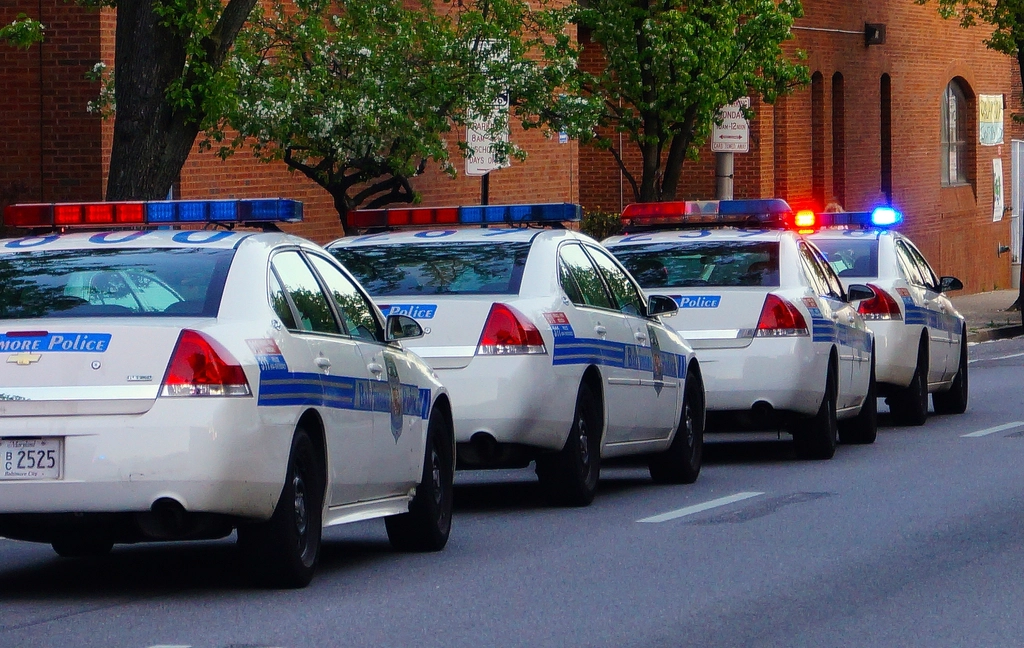 Police vehicle lights along a commercial corridor