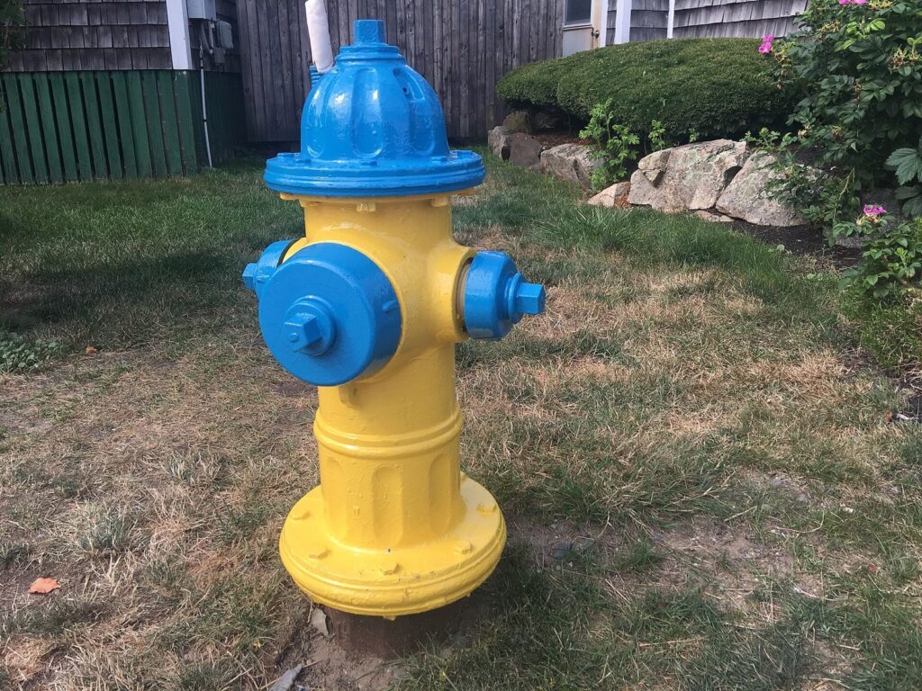Yellow fire hydrant on a grassy roadside